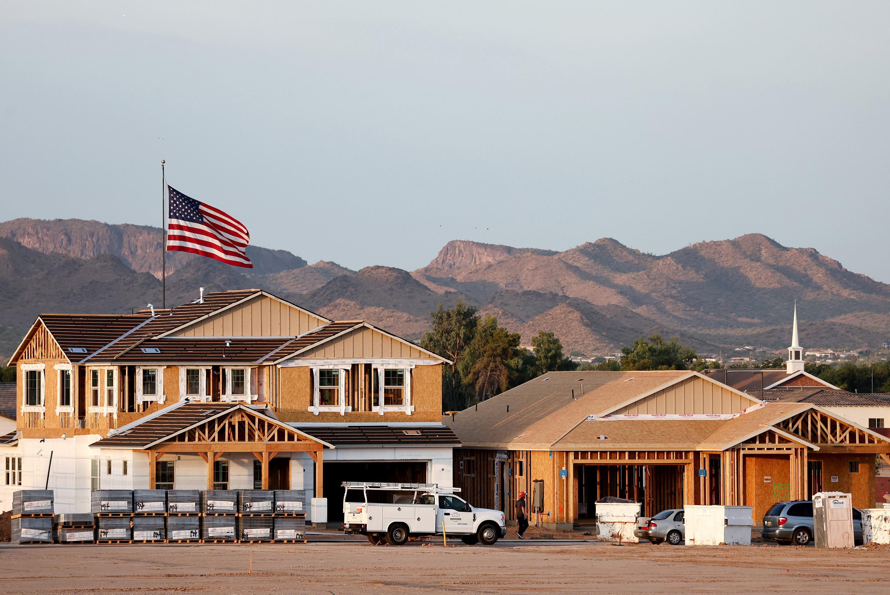 An American flag flies near new home construction at a housing development in the Phoenix suburbs on June 9, 2023, in Queen Creek, Arizona. (Mario Tama/Getty Images North America/TNS)
