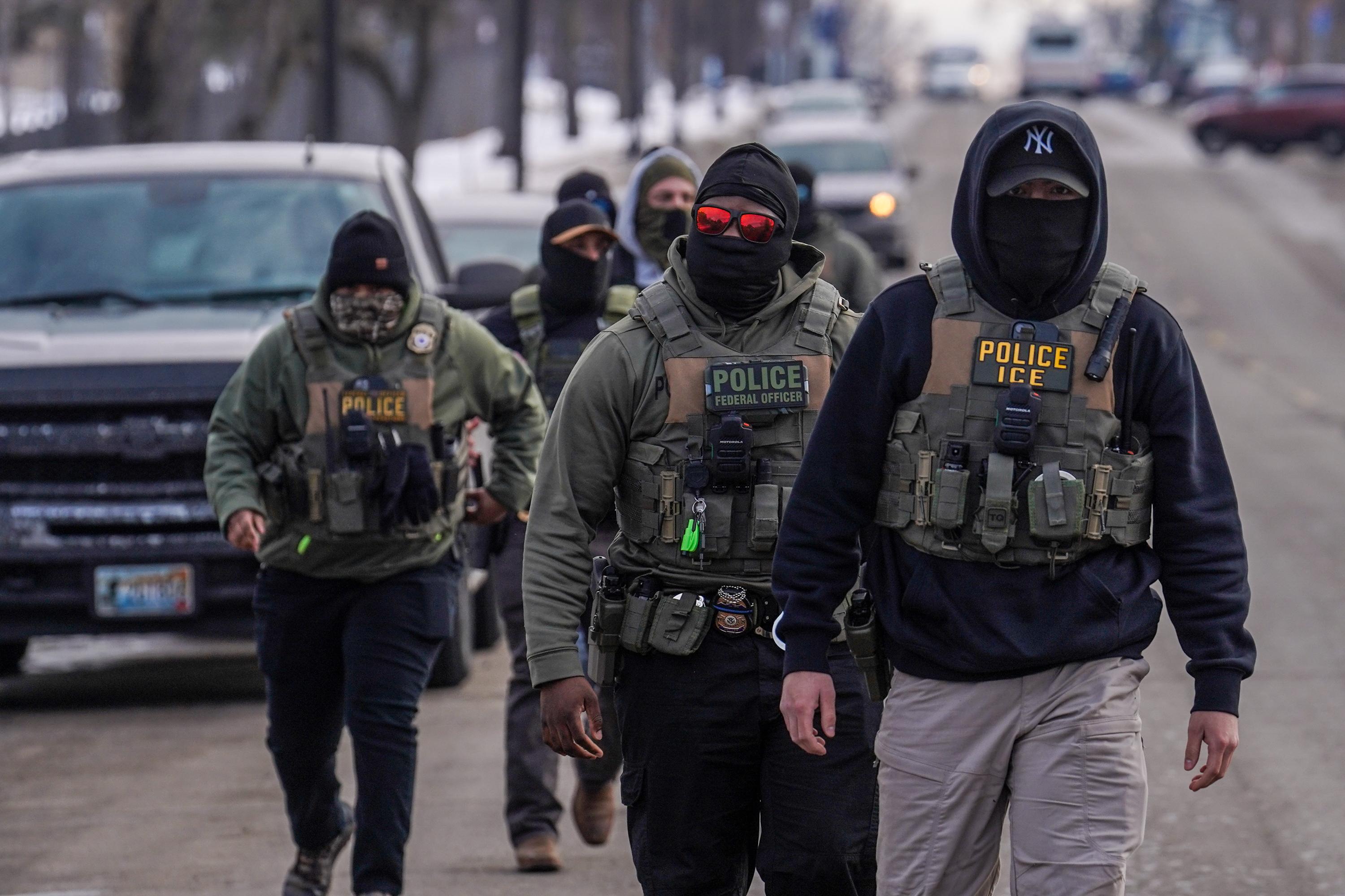 FILE – Federal agents walk down a street while conducting immigration enforcement operations, Thursday, Feb. 5, 2026, in Minneapolis. (AP Photo/Ryan Murphy, File)

